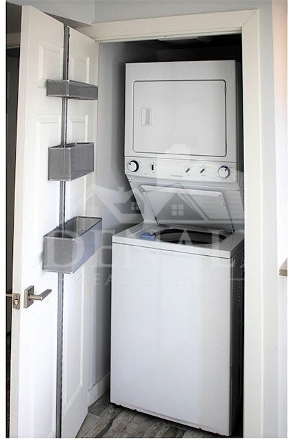 In-home laundry area — representative home at Sir John’s Apartments.