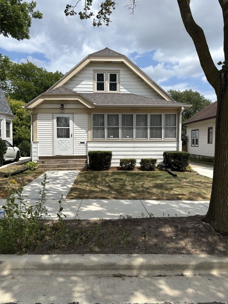 Spacious 3BR Home in a Quiet, Private Setting with Central Air, 2-Car Garage & Sunporch